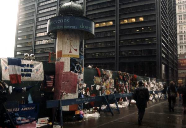 Photo taken 4 months after 9/11. Was a cold and rainy morning that people mostly quietly walking or standing outside ground zero. Went there last weekend now become 9/11 memorial and museum and most people still quietly walking and standing around. The stock and the pain from that day on still cannot fade away and to a lot of us that surely enough to remain for long long time.